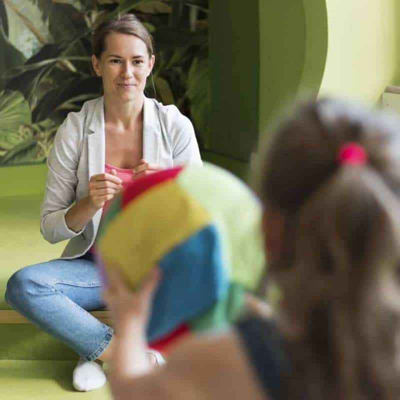blurred-girl-holding-colorful-ball blurred-girl-holding-colorful-ball