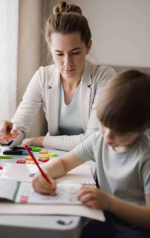 front-view-female-tutor-teaching-child-home front-view-female-tutor-teaching-child-home